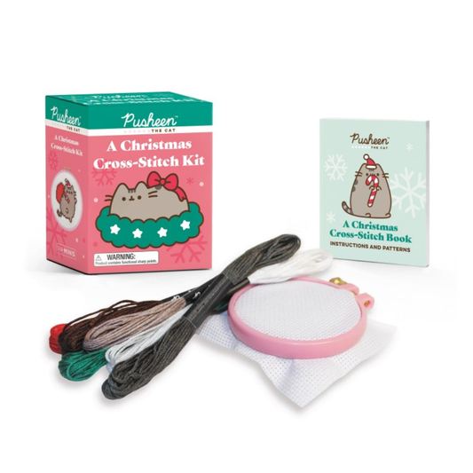 Pusheen Christmas cross-stitch kit with packaging, thread, and needle on a white background