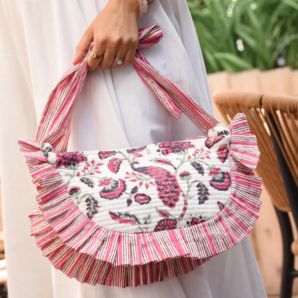 Person holding pink and white purse