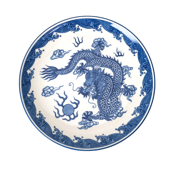 Blue dragon design on a white plate with decorative elements