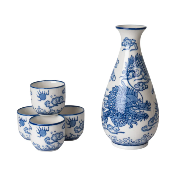 Set of blue and white ceramic dragon-themed cups and a bottle on a white background