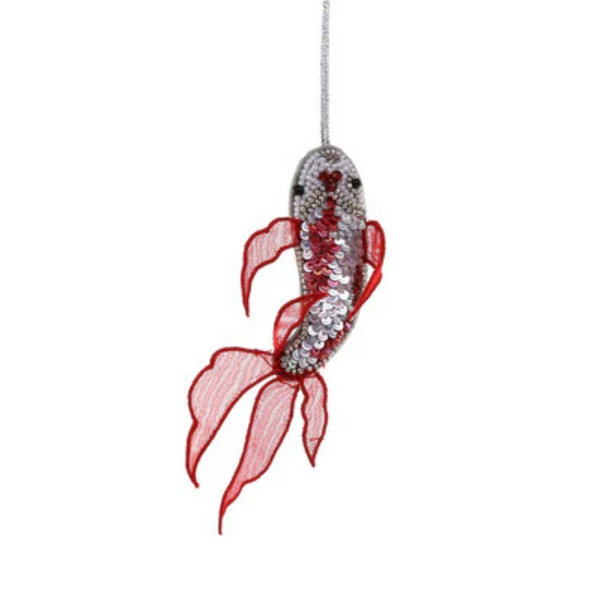 Decorative goldfish ornament with red fins on a white background