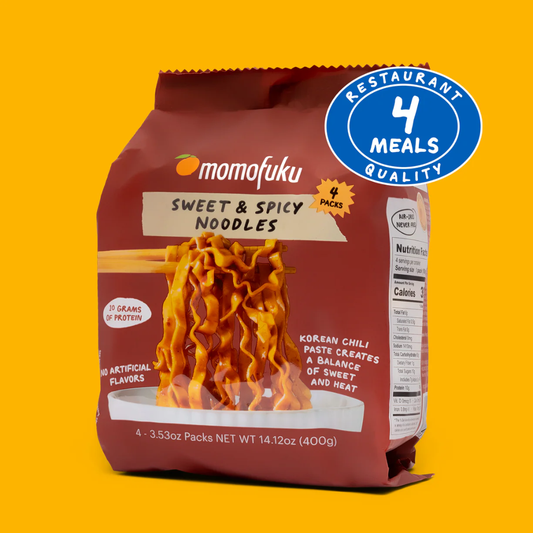 Momofuku Sweet & Spicy Noodles package on a yellow background with a '4 Meals Quality' badge.
