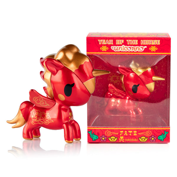Red and gold unicorn figurine with packaging on a white background