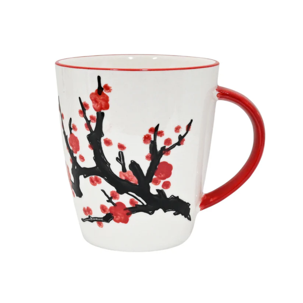 White mug with red interior, black branch with red flowers design, and red handle on a white background