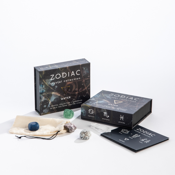 Zodiac crystal collection packaging with crystals and cards on a white background