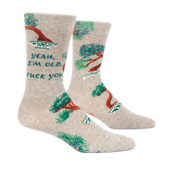Beige socks with green and red designs on a white background