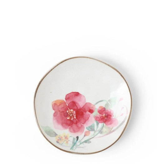 A small ceramic plate with a floral design with a brown rim.