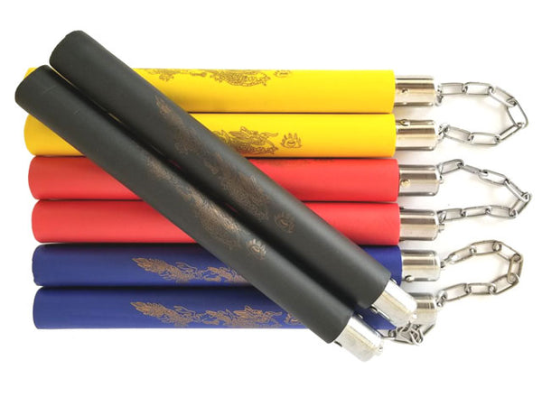 Four foam wrapped nunchakus. The black colored foamed nunchaku is on top of the yellow, red and blue nunchakus