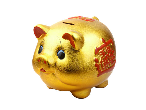Golden colored piggy bank with red character stamped on its side