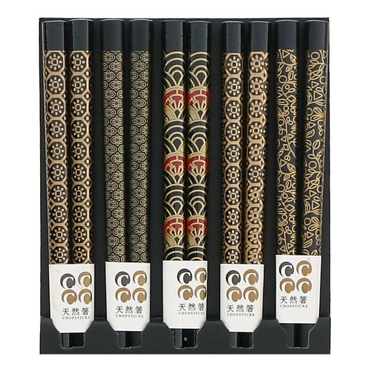 Five pairs of black chopsticks with assorted patterns.