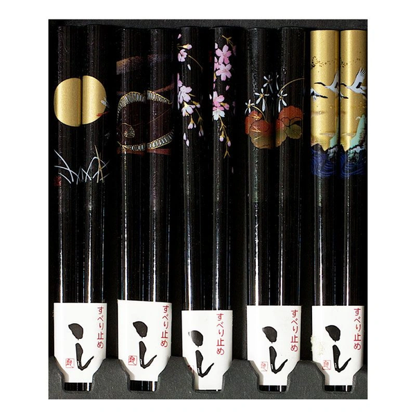Five pairs of black chopsticks with assorted patterns.
