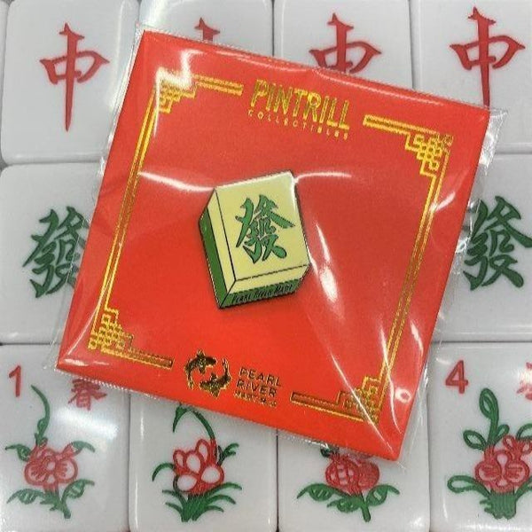 Mahjong "fortune" pin with a background of mahjong tiles