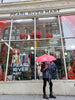 Man holding red Pearl River umbrella in front of Pearl River store