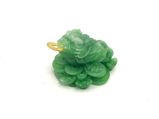 three-legged toad on coins figurine in green color.