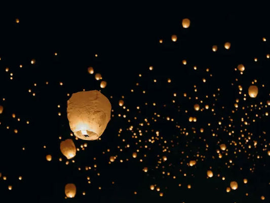 Group of Sky lanterns flying in the night sky