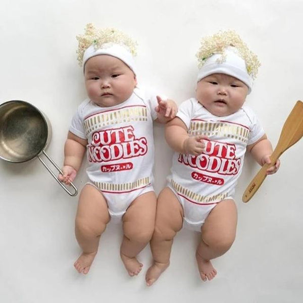 Adorable twin babies wearing Cute Noodles onesies with noodle hats