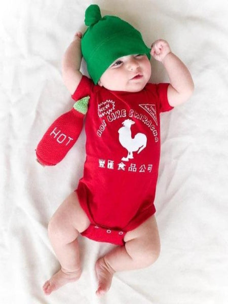 Cute baby wearing red sriracha rooster onesie and green hat