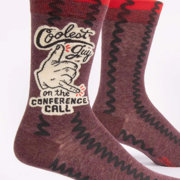 Coolest Guy On The Conference Call Novelty Socks: Maroon socks with thick black squiggles, hand gesture with thumb and pinky out, reads "Coolest Guy on the Conference Call"