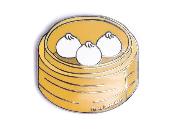Delicious enamel pin of three little juicy buns in a bamboo steamer