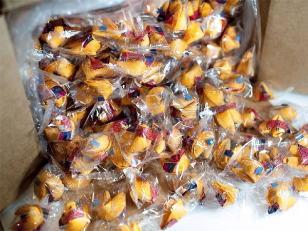 individually wrapped fortune cookies falling out of a box