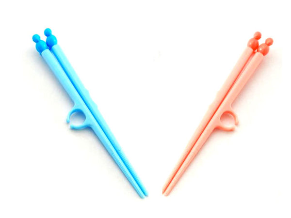 pink and blue childrens practice chopsticks