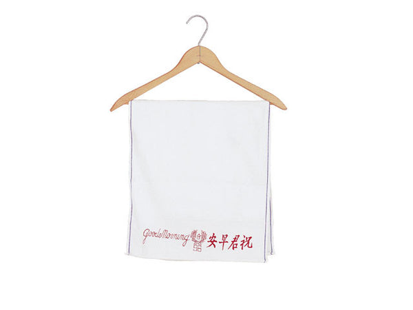 A soft vintage white towel with red Good Morning in English and Chinese embroidery