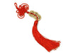 Coins ornament with red tassel laid down. This one holds three coins