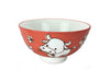 A vibrant red bowl decorated with a cute zodiac ox