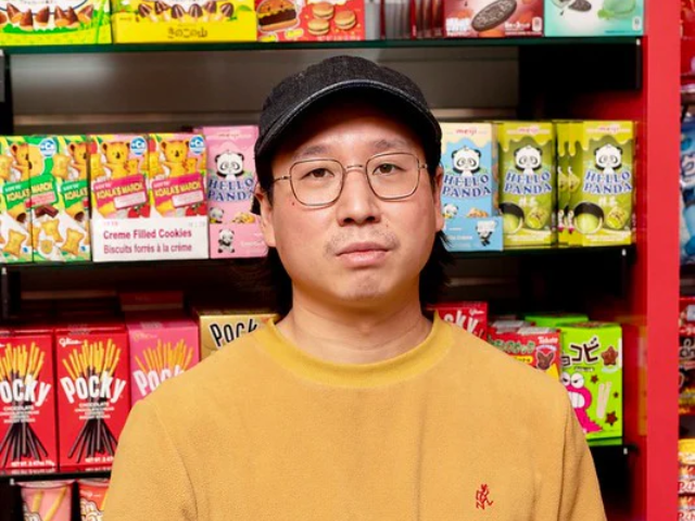 Pintrill founder Andrew Yung in front of snack wall of Pearl River Mart in Chelsea Market