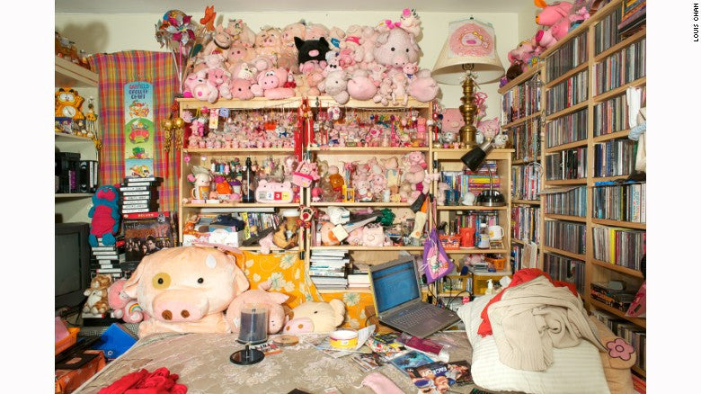 Shelves with many pink stuffed animal in front of bed with more stuffed toys