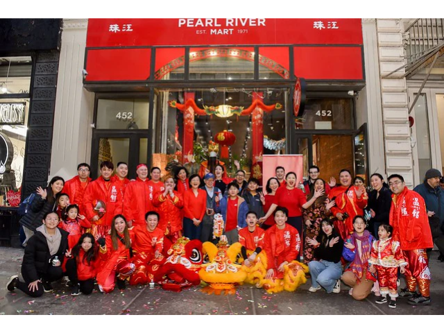 Wan Chi Ming lion dance troupe with Pearl River Mart employees in front of Pearl River Mart's Soho location