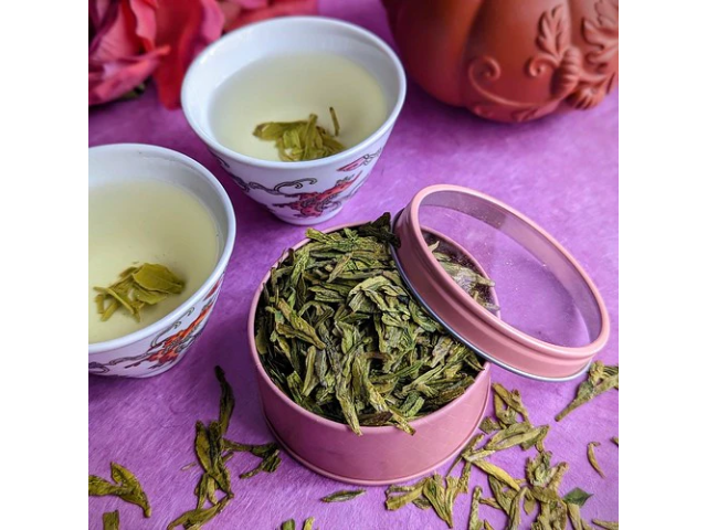 Ming Qian Longqing tea in pink canister with tea cups