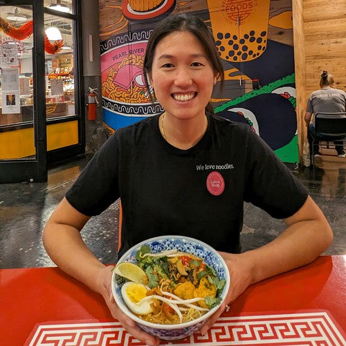 Cassandra Lam with bowl of laksa at Pearl River Mart Foods