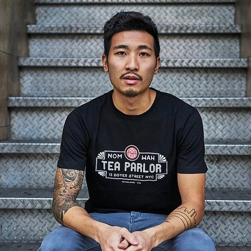 Male model wearing black Nom Wah T-shirt