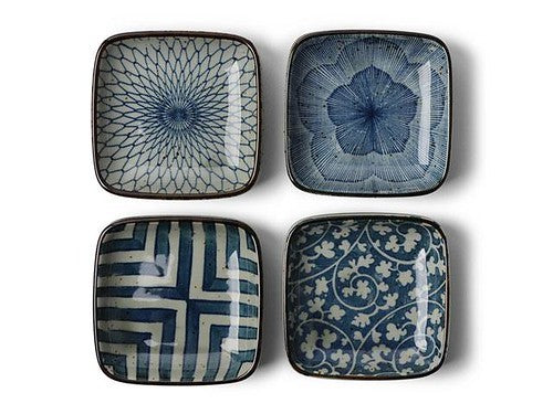 Four blue on white sauce dishes in assorted patterns