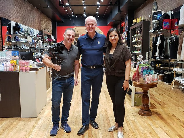 news anchor Scott Swan and photojournalist Steve Rhodes from WTHR with Joanne Kwong in the Soho location of Pearl River Mart