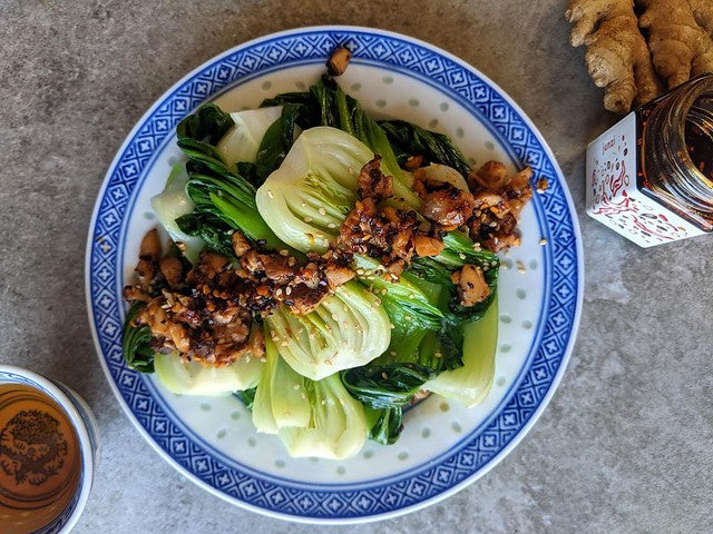 Blue and white plate with bok choy and mushrooms