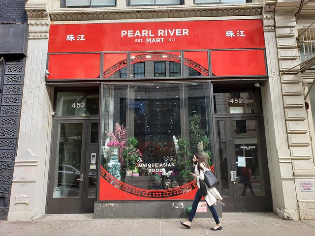 Exterior of Pearl River Mart at 452 Broadway with woman walking past