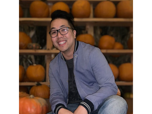 Mathew Wong in front of pumpkin display