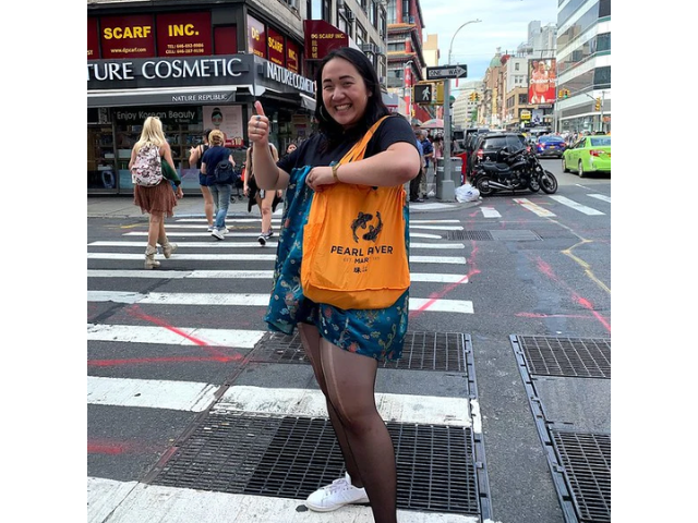 Pearl River Mart intern Pearl Ngai with yellow Pearl River bag in Chinatown