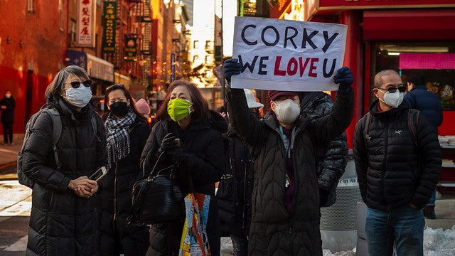 Group of mourners in Chinatown with sign, Corky We Love U