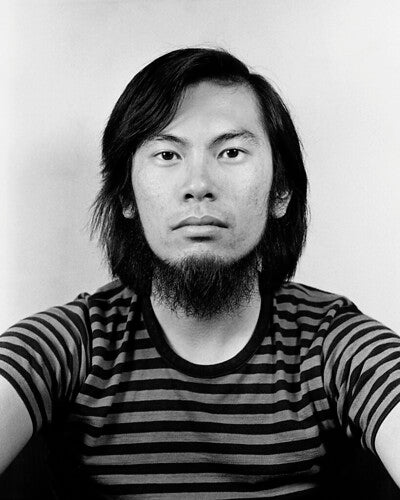 Black and white portrait of photographer Corky Lee in 1973