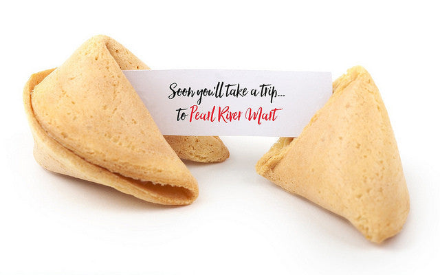 Fortune cookie with message, "Soon you'll take a trip to Pearl River Mart"