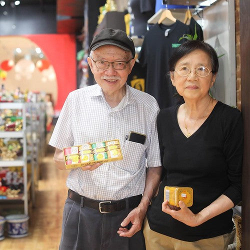 Mr. and Mrs. Chen at the 452 Broadway location of Pearl River Mart, holding Bee & Flower soap and jasmine tea