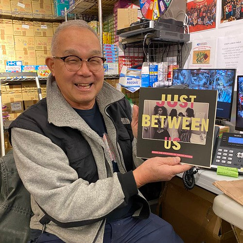 Artist Arlan Huang with the Just Between Us catalog