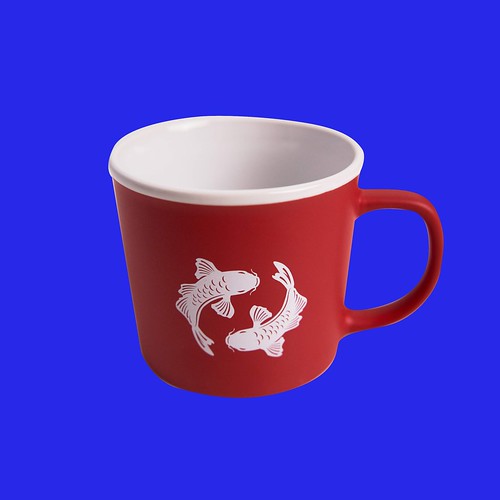 Red Pearl River Mart mug showing white double fish