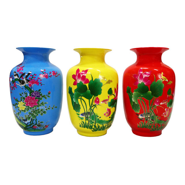 Colorful vases in blue, yellow, and red with bird and flower patterns