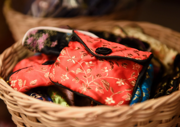 Small colorful brocade purses in a basket