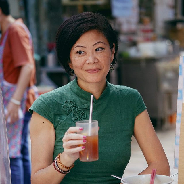 Chef and photographer Christine Wong in green dress with drink