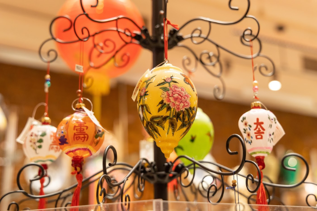 Display of glass Christmas ornaments with floral and Chinese character designs